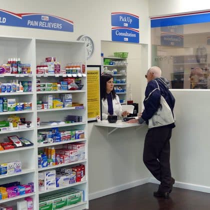 Pharmacist Roseanne Papoyan helping a customer at the pickup and consultation counter